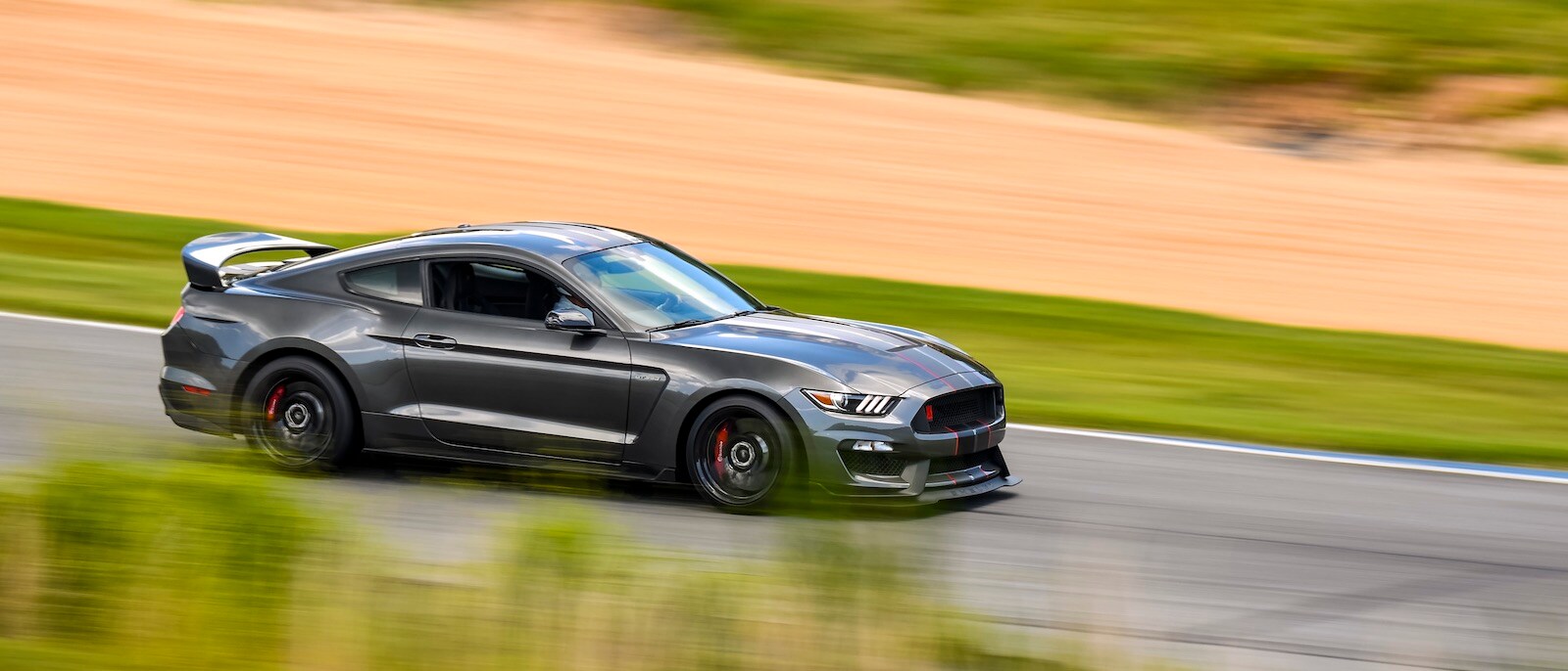 2020 Ford Mustang BULLITT A grey 2020 Ford Mustang BULLITT driving on a track