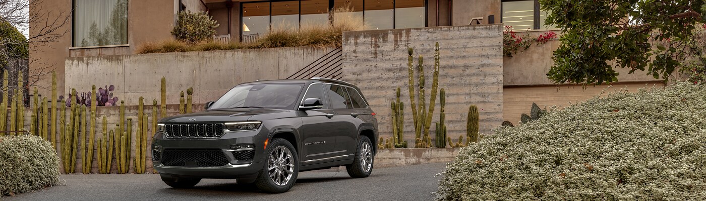 Jeep Grand Cherokee Summit Jeep Grand Cherokee Summit parked in front of a modern home