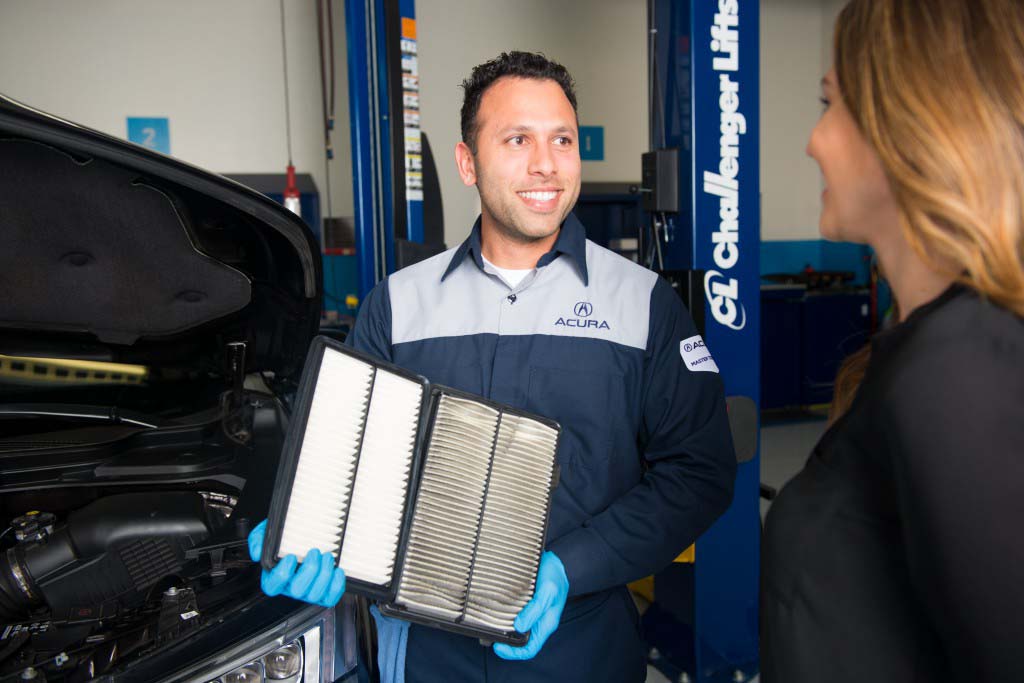 Cabin Air Filter Replacement at Bobby Rahal Acura in Mechanicsburg, PA | Acura Technician Doing a Side by Side Comparison of an Old and New Air Filter
