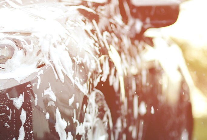 How to Get Your Car Summer Ready at Bobby Rahal Acura in Mechanicsburg, PA | Black car cover in water and soap for a car wash