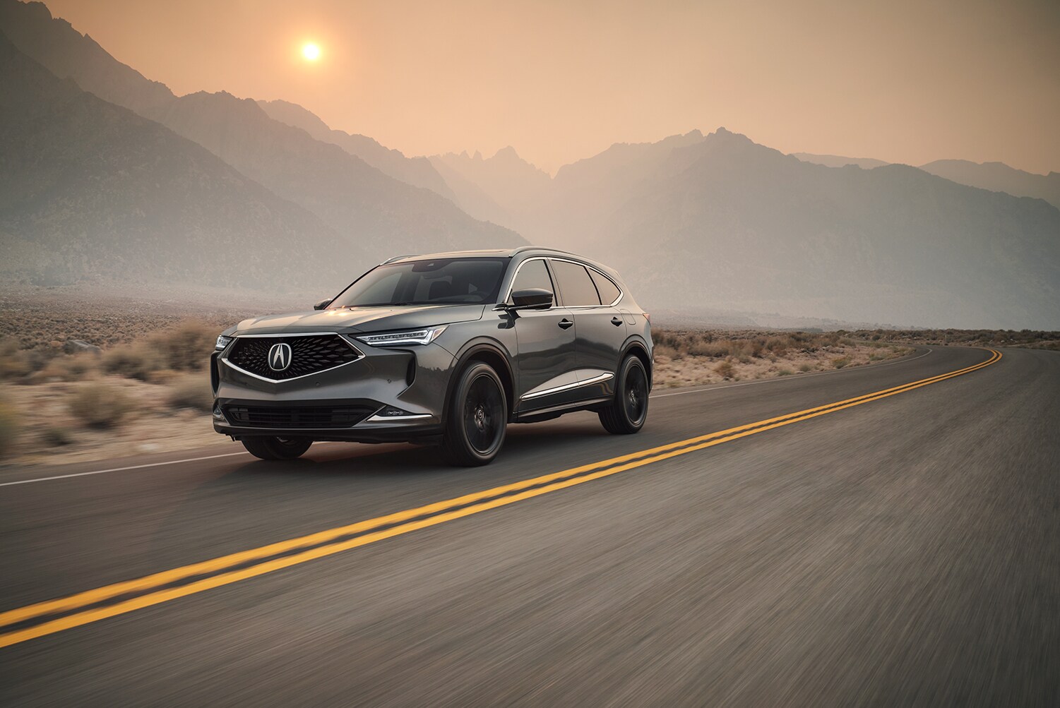 Bobby Rahal Acura is a Car Dealership near Lewisberry PA | The 2022 Acura MDX driving at sunset