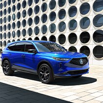 Compare the 2020 Acura MDX and the 2022 Acura MDX at Bobby Rahal Acura | MDX parked in city