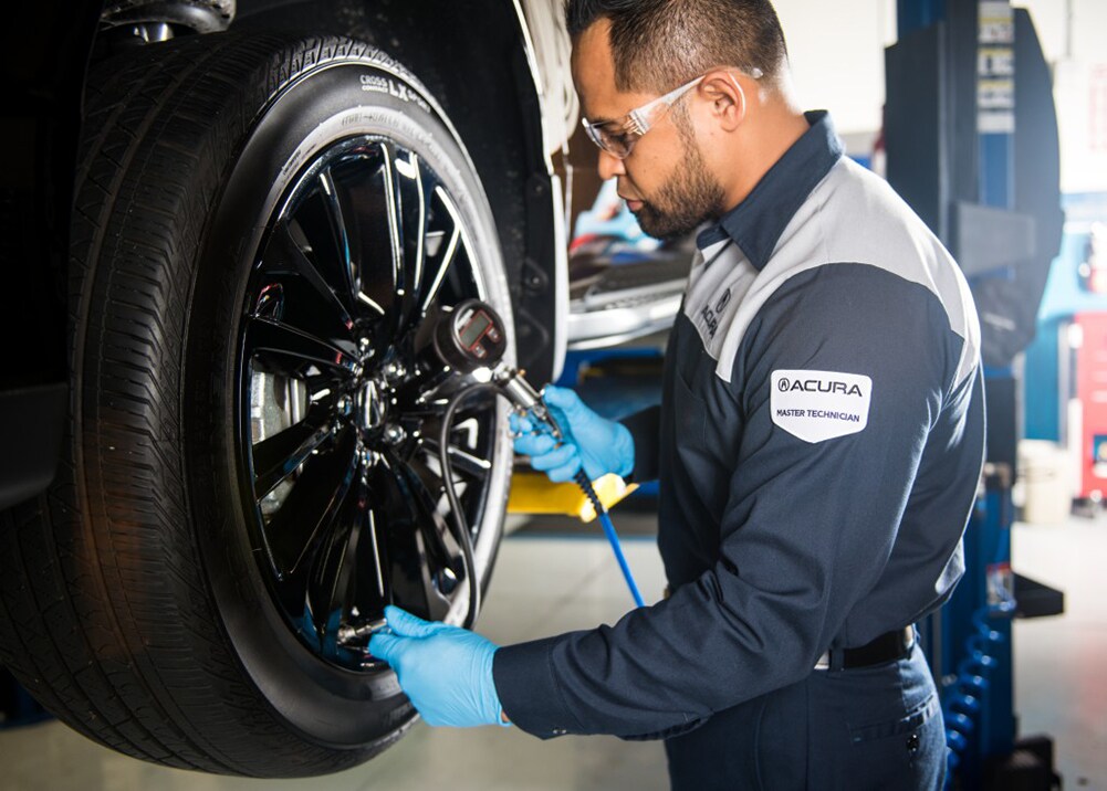How to prepare your Acura for the winter season in Mechanicsburg, PA at Bobby Rahal Acura | Acura service technician checking tires before winter