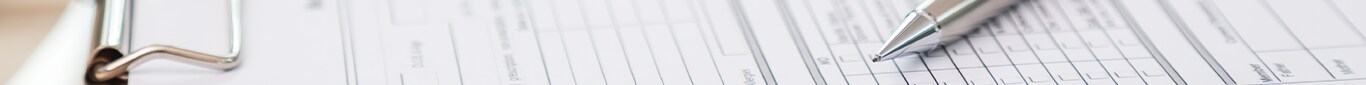 Vehicle Registration Taxes and Fees at Bobby Rahal Acura in Mechanicsburg, PA | Silver pen laying on top of unfilled paperwork