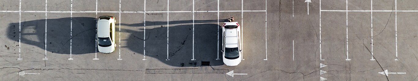 Enjoy A Test Drive At Bobby Rahal Acura in Mechanicsburg, PA | Empty parking lot with only 2 white vehicles parked