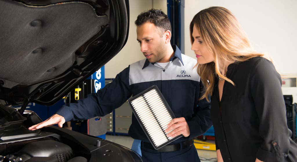 Basic Car Maintenance and Servicing Checklist | Bobby Rahal Acura | Acura service technician showing customer what maintenance needs to be done