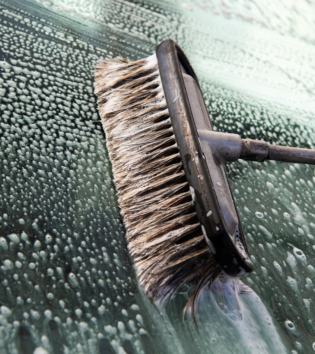 Remove Dead Bugs From Front of Cars at Bobby Rahal Acura in Mechanicsburg, PA | Car brush cleaning front windshield with soap and water