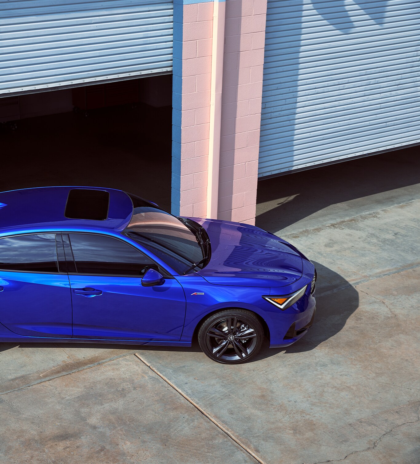 New 2023 Integra at Bobby Rahal Acura | Blue 2023 Acura Integra driving out of a parking garage door