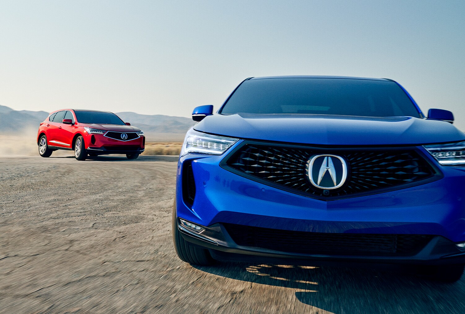 All-New 2022 Acura RDX at Bobby Rahal Acura | Two 2022 Acura RDXs driving on dirt road