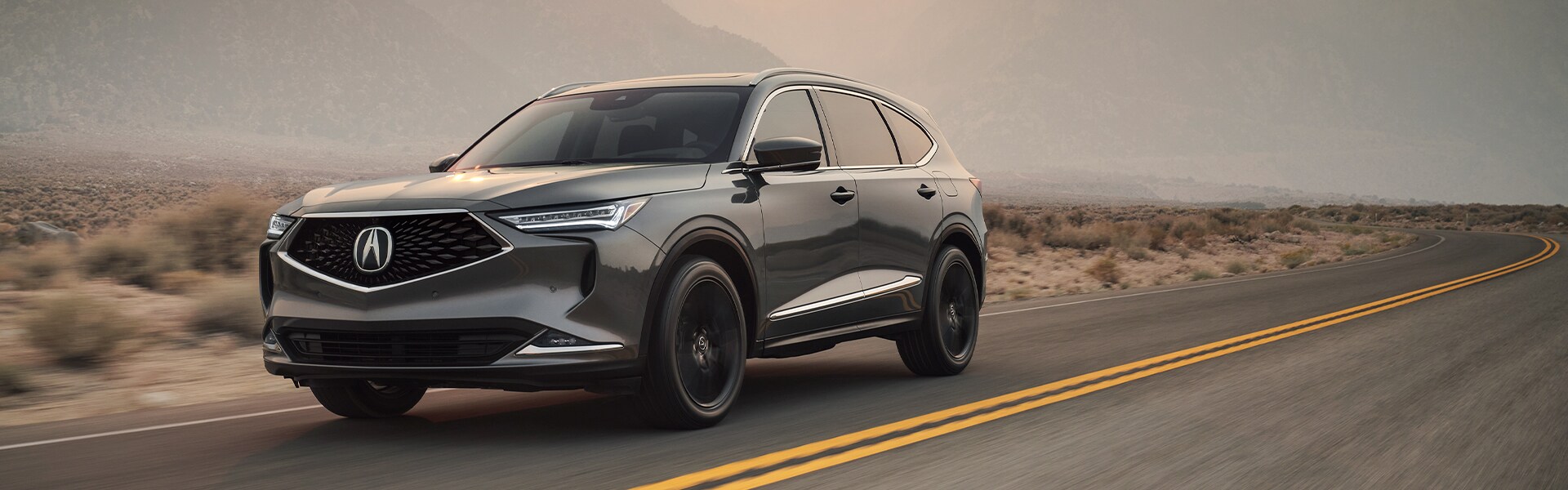 Bobby Rahal Acura is a Car Dealership near Perry County PA | Silver Acura MDX Driving on Road Through Desert