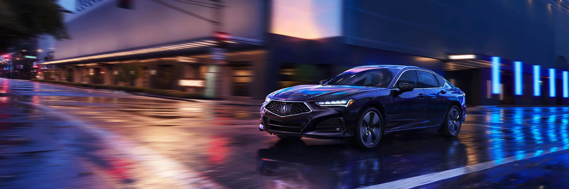 All-New 2022 Acura TLX at Bobby Rahal Acura | Modern Steel Metalic 2022 Acura TLX Facing Left Driving Through City at Night with Neon Lights