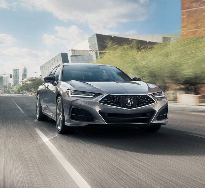 Bobby Rahal Acura is a Car Dealership near Perry County PA | Silver Acura TLX Driving Through City