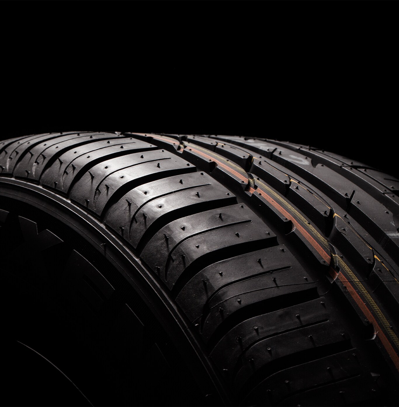 What is Tire and Rim Protection? | Bobby Rahal Acura | Detail close up of a new tire treads with red and yellow marks on it