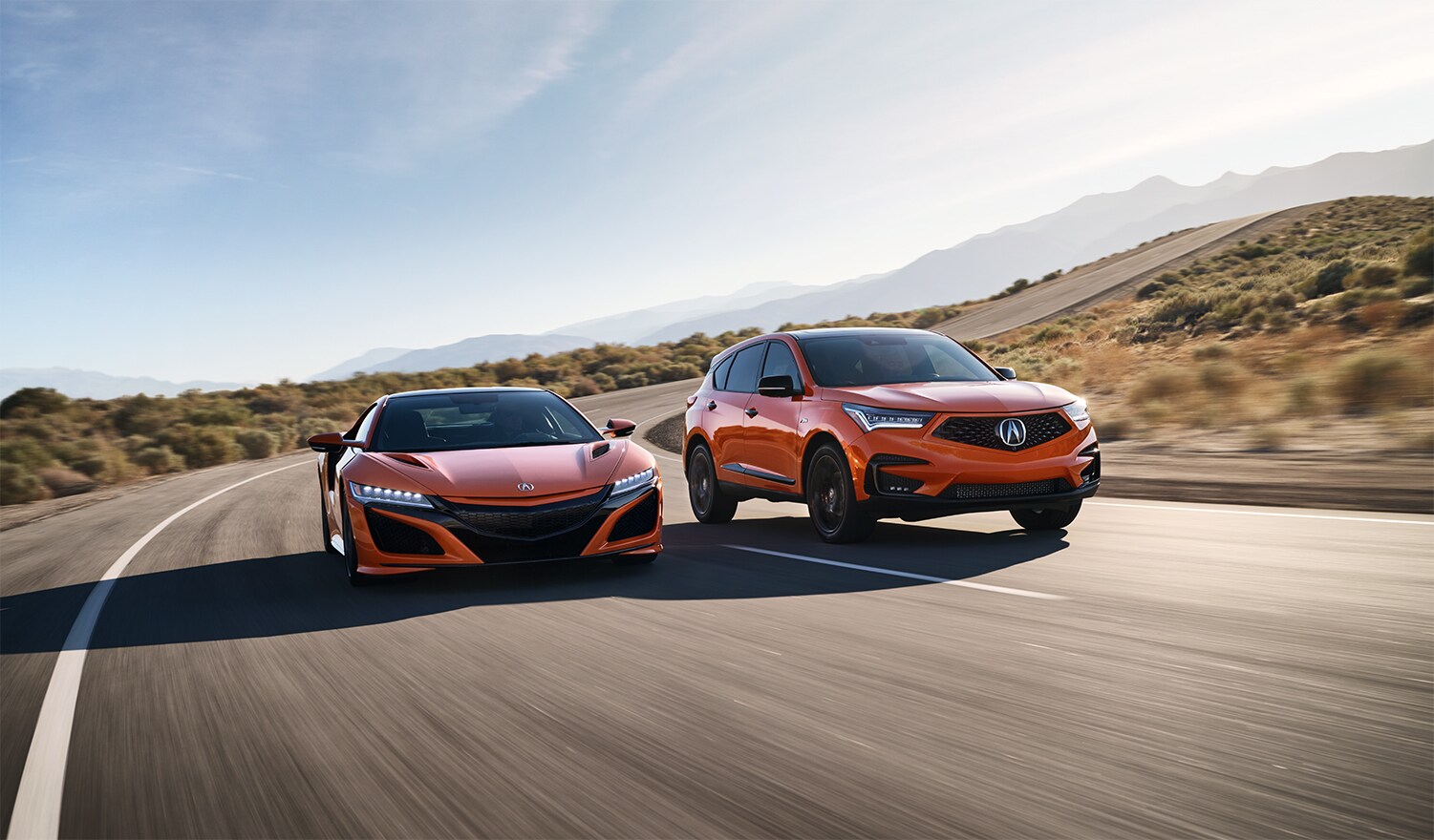 Bobby Rahal Acura is a Car Dealership near Lewisberry PA | The 2021 Acura RDX driving next to a 2021 Acura NSX