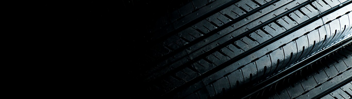 What is Tire and Rim Protection? | Bobby Rahal Acura | Tire treads fading away going from right to left in a black background