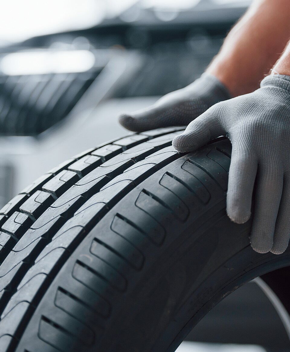 What is a Tire Rotation? at Bobby Rahal Acura | Two Hands on a Car Tire