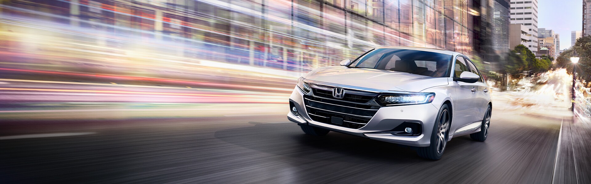 Bobby Rahal Honda is a Car Dealership near Lewisberry PA | White Honda Accord Driving Through City at Night