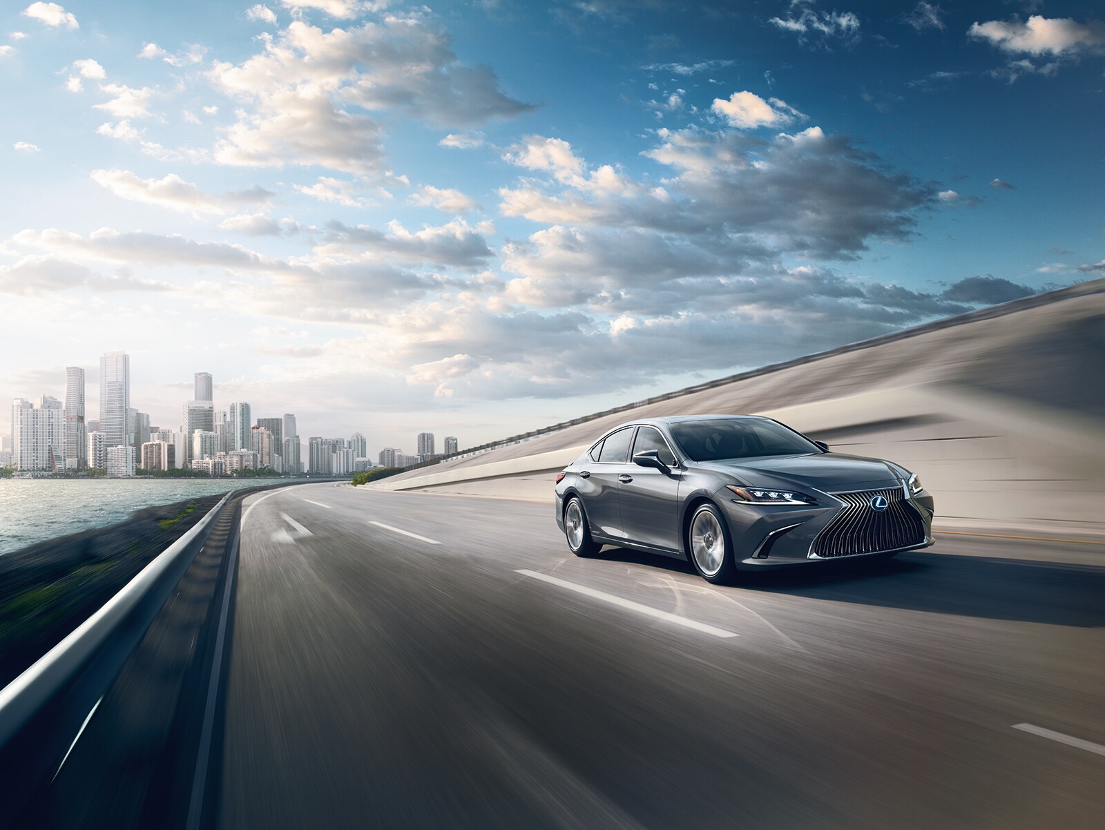 Model Features of the 2020 Lexus ES and ES Hybrid | Grey 2020 Lexus ES running on road Model Features of the 2020 Lexus ES and ES Hybrid | Grey 2020 Lexus ES running on road