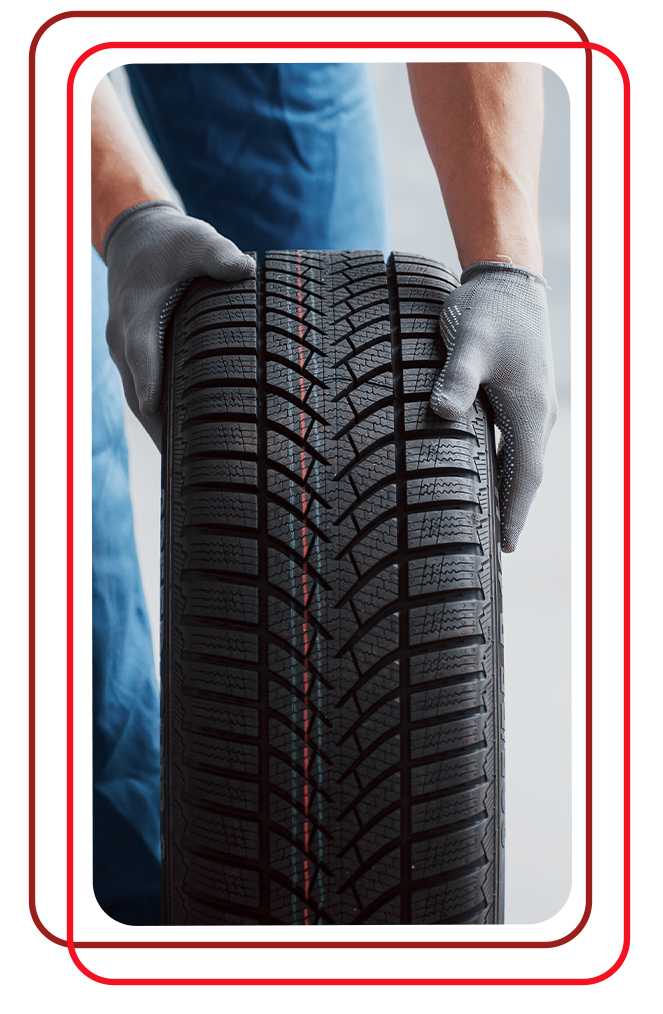 The Cold Facts of Winter Tires | Bobby Rahal Lexus of Lancaster County in Ephrata, PA | Mechanic with grey color gloves is rolling a new snow tire on the ground