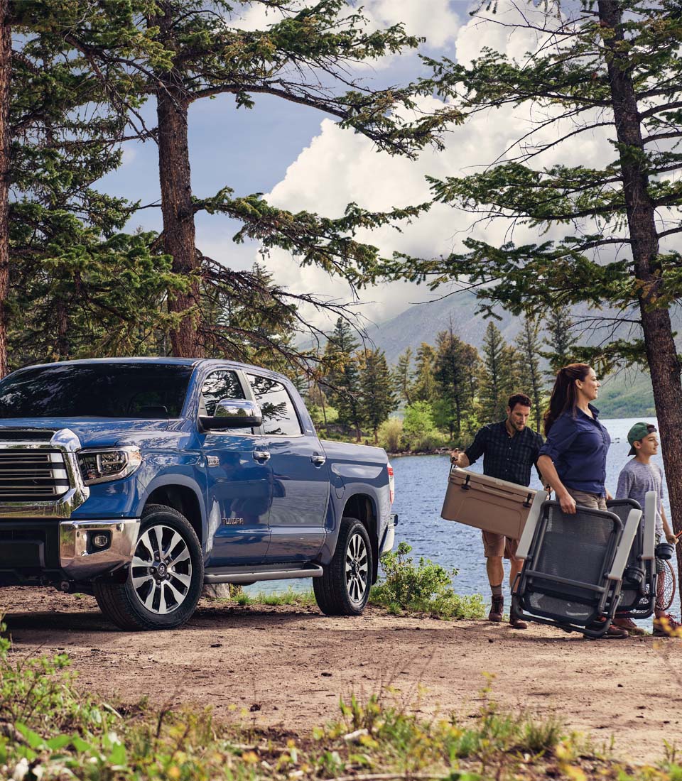 Understanding Your Toyota’s Emergency Lights at Bobby Rahal Toyota in Mechanicsburg, PA | A Family of Three Walking Towards a Lake for a Fishing Trip With the 2021 Toyta Tundra in the Background