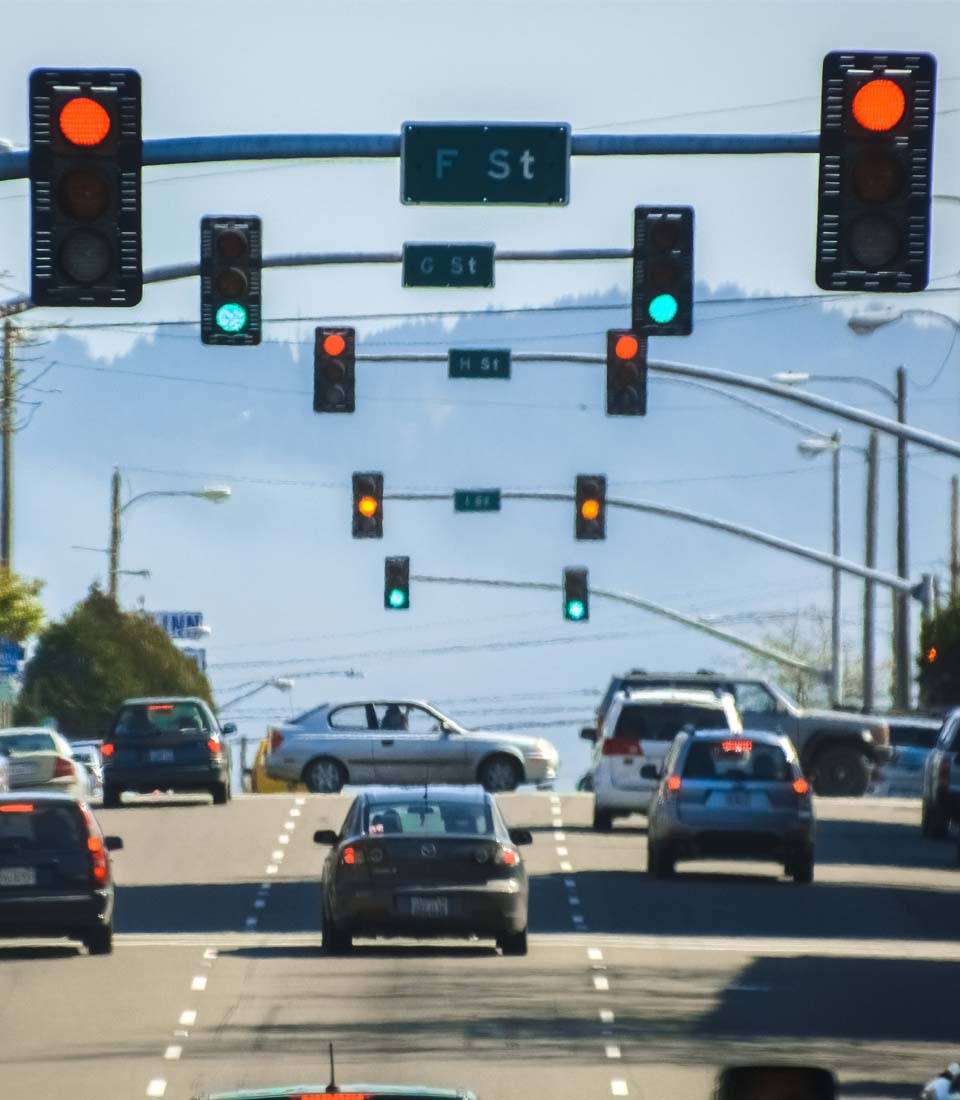 Understanding Your Toyota’s Emergency Lights at Bobby Rahal Toyota in Mechanicsburg, PA | Multiple Sets of Traffic Light Looking Down A Busy Street