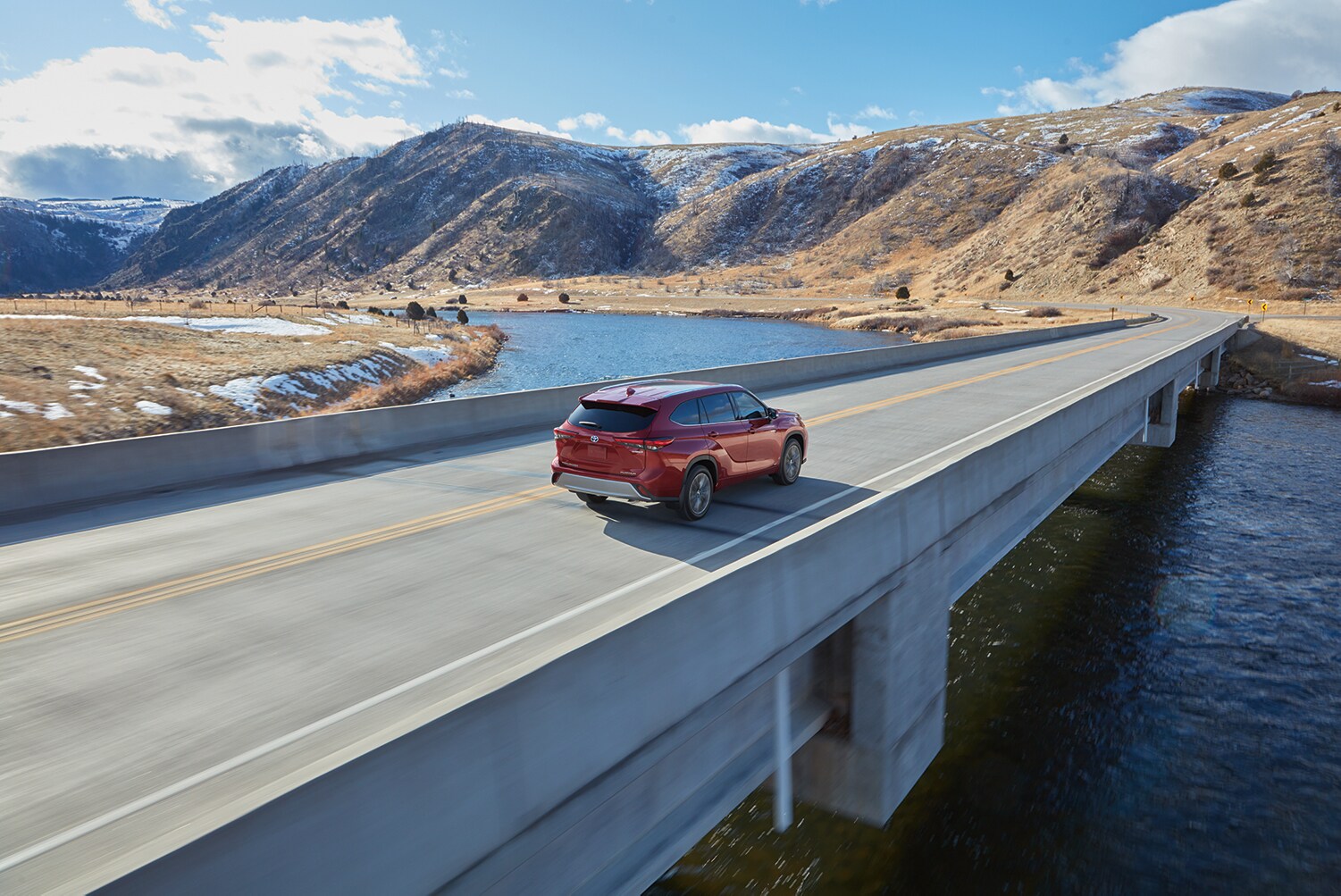 Toyota Hybrid for Everyone at Bobby Rahal Toyota | 2022 Toyota Highlander Hybrid driving away on a bridge