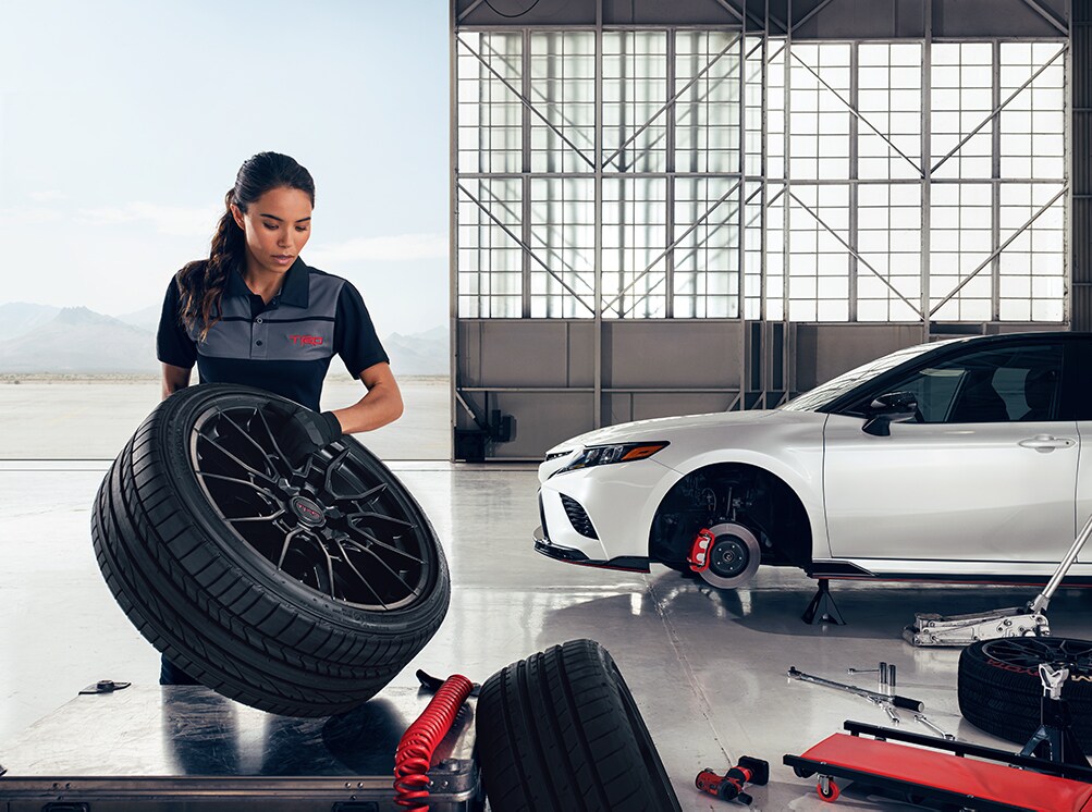 How to prepare your Toyota for the winter season in Mechanicsburg, PA at Bobby Rahal Toyota | Toyota service technician inspecting tires on a 2021 Toyota Avalon