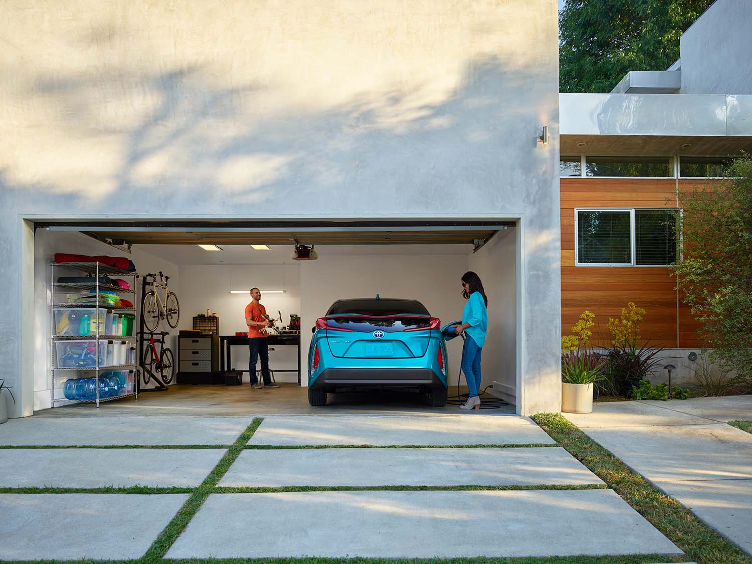 How to prepare your home for your new Plug-in Hybrid Vehicle at Bobby Rahal Toyota in Mechanicsburg, PA | Woman charging Prius Prime in her home garage