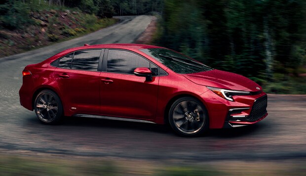 2024 Corolla at Bobby Rahal Toyota | red 2024 Toyota Corolla driving down the road