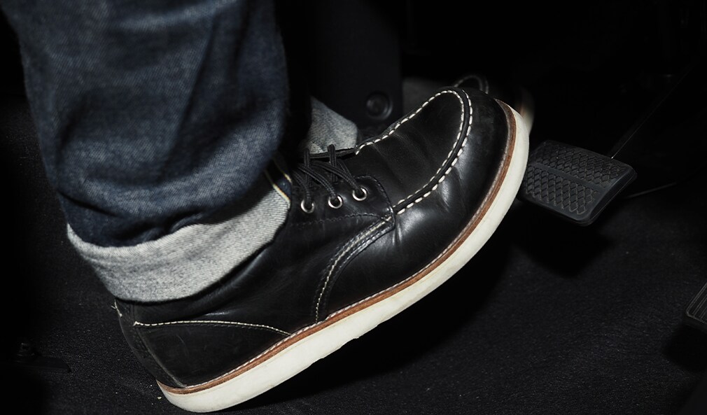 Learn Maintenance Warning Signs at Bobby Rahal Toyota in Mechanicsburg, PA | Person wearing jeans and black color boots pushing the gas pedal with his foot