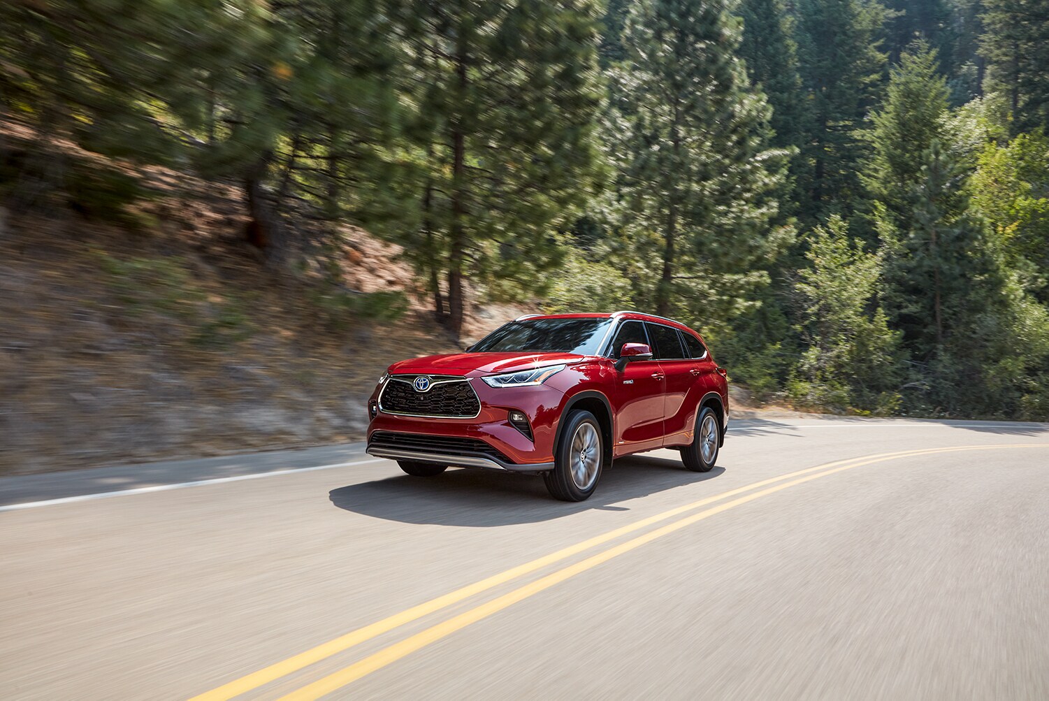 Toyota Hybrid for Everyone at Bobby Rahal Toyota | 2022 Toyota Highlander Hybrid driving on mountain road