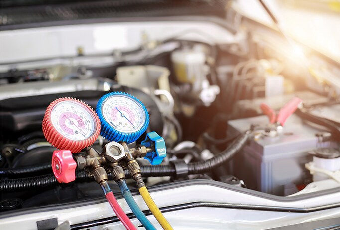 How to Get Your Car Summer Ready at Bobby Rahal Toyota in Mechanicsburg, PA | A/C charger connected to A/C outlets located in the engine bay