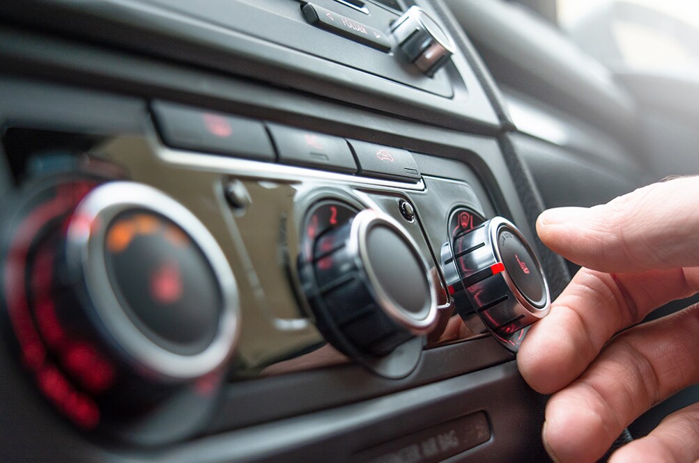How to prepare your Toyota for the winter season in Mechanicsburg, PA at Bobby Rahal Toyota | Man turning on heat in car during the winter