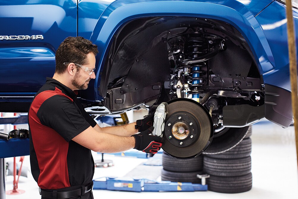 Bobby Rahal Toyota is a Car Dealership near Enola PA | Toyota service technician putting new brakes on a Tacoma
