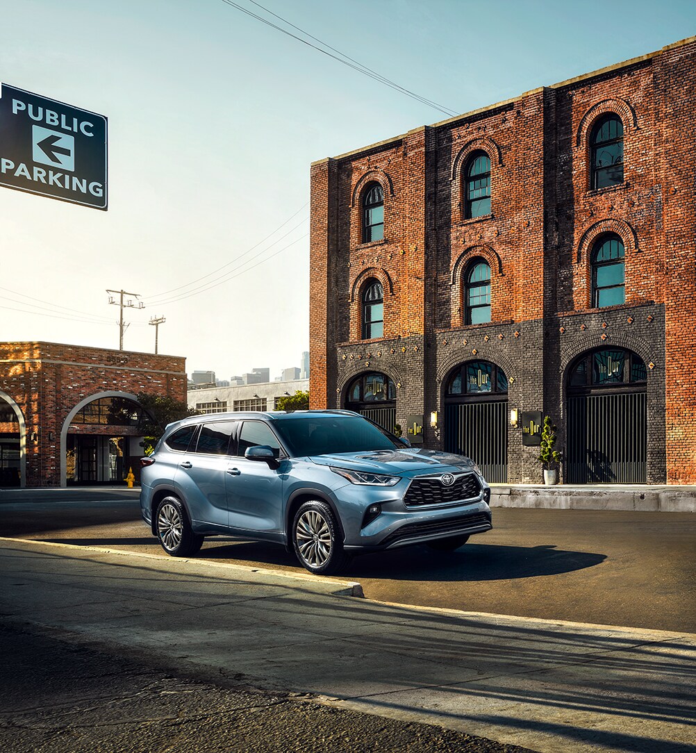 Comparison of the 2020 Toyota Highlander and the 2020 Subaru Ascent at Bobby Rahal Toyota of Mechanicsburg | 2020 Toyota Highlander parked next to brick building