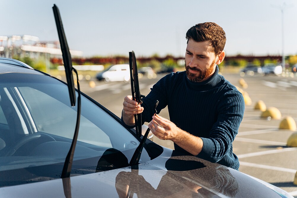 How to prepare your Toyota for the winter season in Mechanicsburg, PA at Bobby Rahal Toyota | Man replacing windshield wipers before the winter