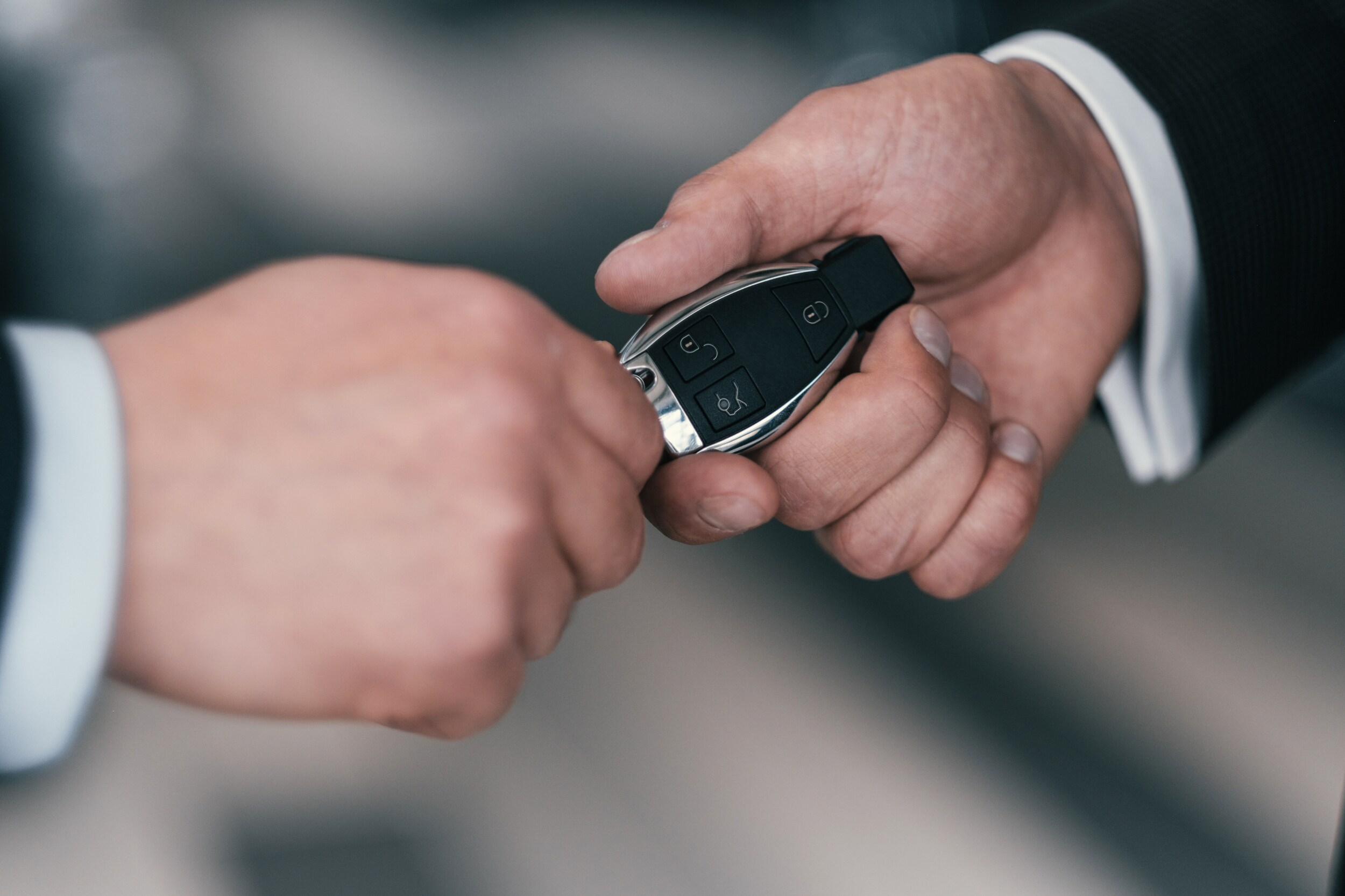 Bobby Rahal Toyota is a Car Dealership near Perry County PA | Two men's hands exchanging a Key Fob