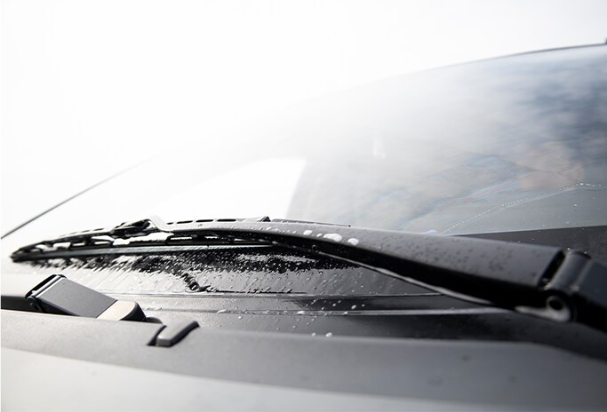How to Get Your Car Summer Ready at Bobby Rahal Toyota in Mechanicsburg, PA | Close up picture of wiper blades on windshield on a cloudy day