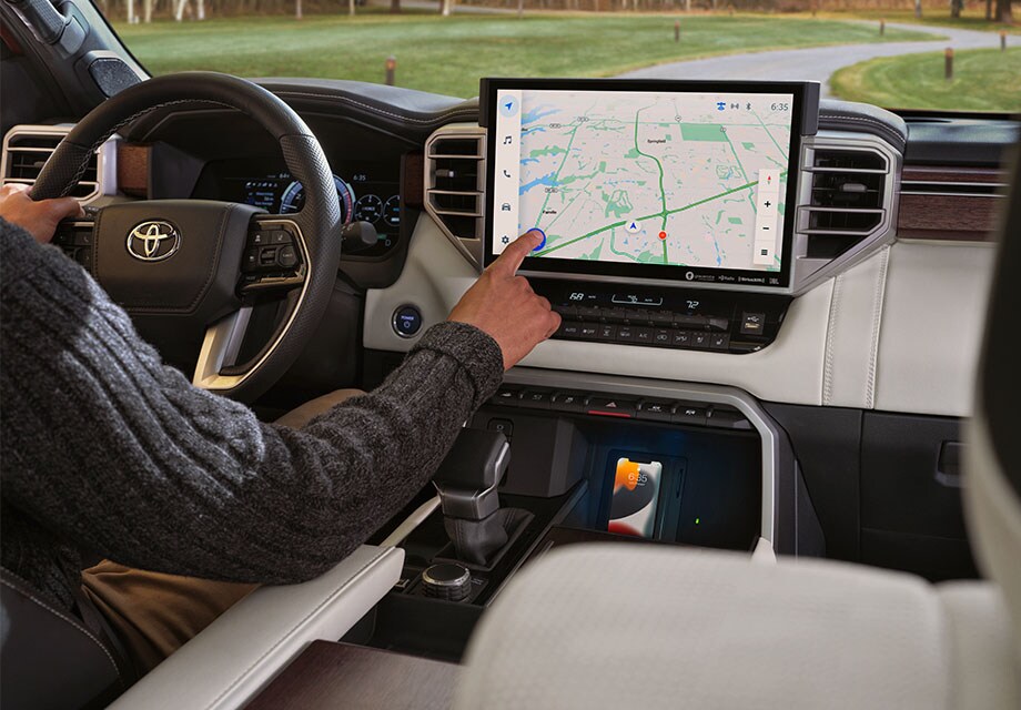 Model Features of the All-New 2023 Toyota Sequoia at Bobby Rahal Toyota | Interior shot of Hand Interacting with Center Console of a 2023 Toyota Sequoia