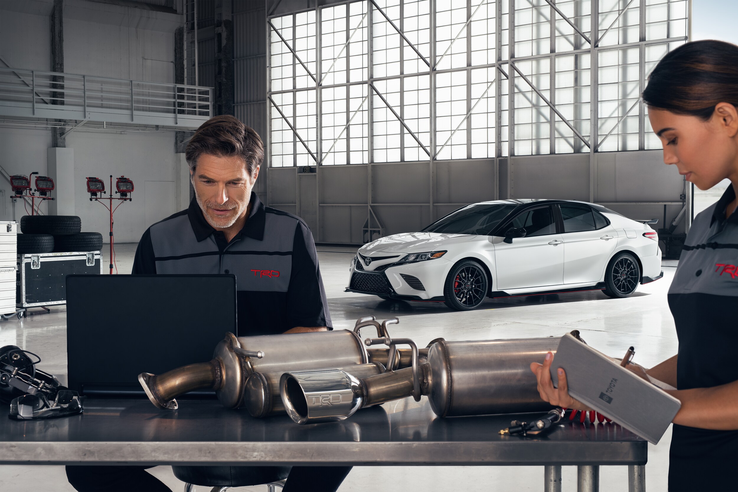 Bobby Rahal Toyota is a Car Dealership near Mechanicsburg, PA | Garage Employees working on mufflers
