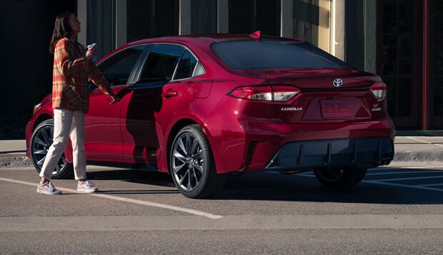 2024 Corolla at Bobby Rahal Toyota | Woman about to enter through the driver side of her 2024 Toyota Corolla