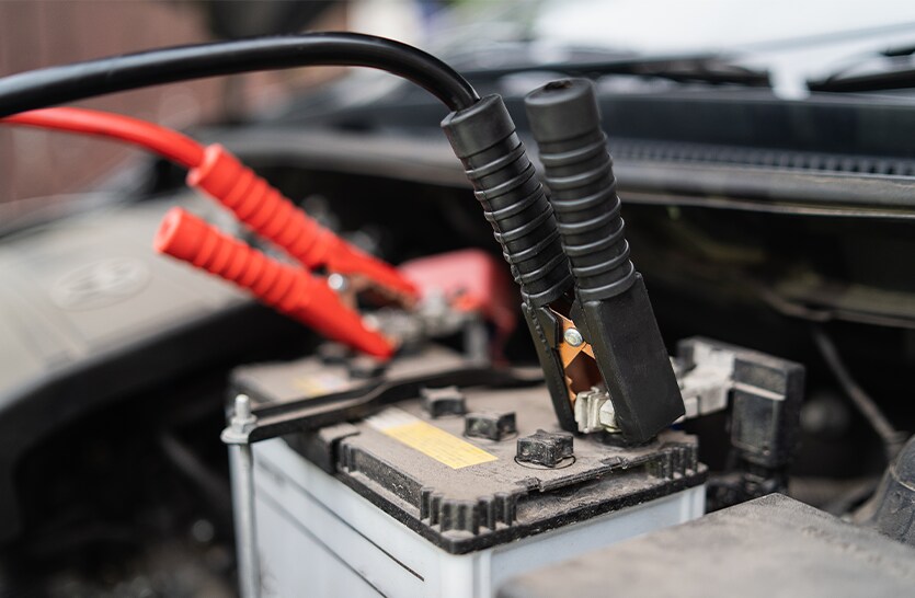Everything You Need to Know about Your Car Battery at Bobby Rahal Toyota | Black & Red Battery cables connected to dead battery