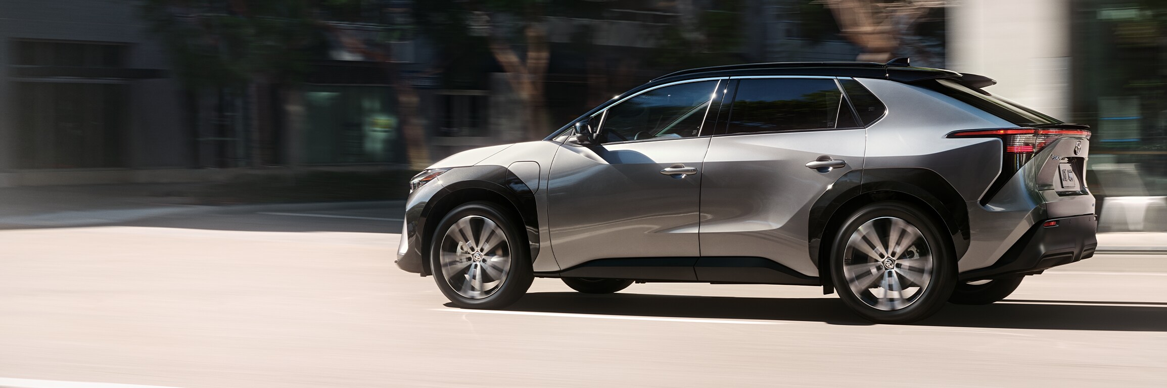 The All-New 2023 Toyota BZ4X at Bobby Rahal Toyota in Mechanicsburg, PA | Toyota BZ4X driving by the city during the day