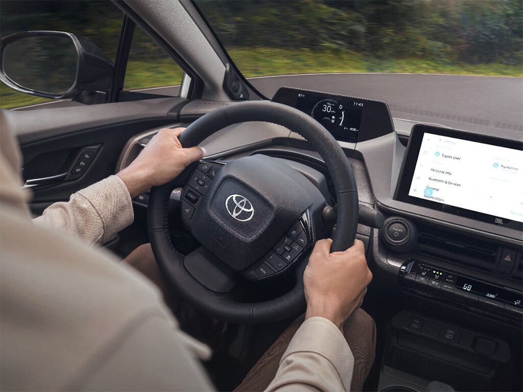 2023 Toyota Prius at Bobby Rahal Toyota in Mechanicsburg, PA | Person sitting in the drivers seat of a 2023 Toyota Prius with their hands on the steering wheel