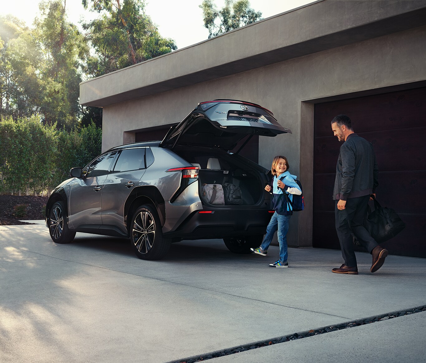 The All-New 2023 Toyota BZ4X at Bobby Rahal Toyota in Mechanicsburg, PA | Father and son packing up the trunk of the Toyota BZ4X with bags