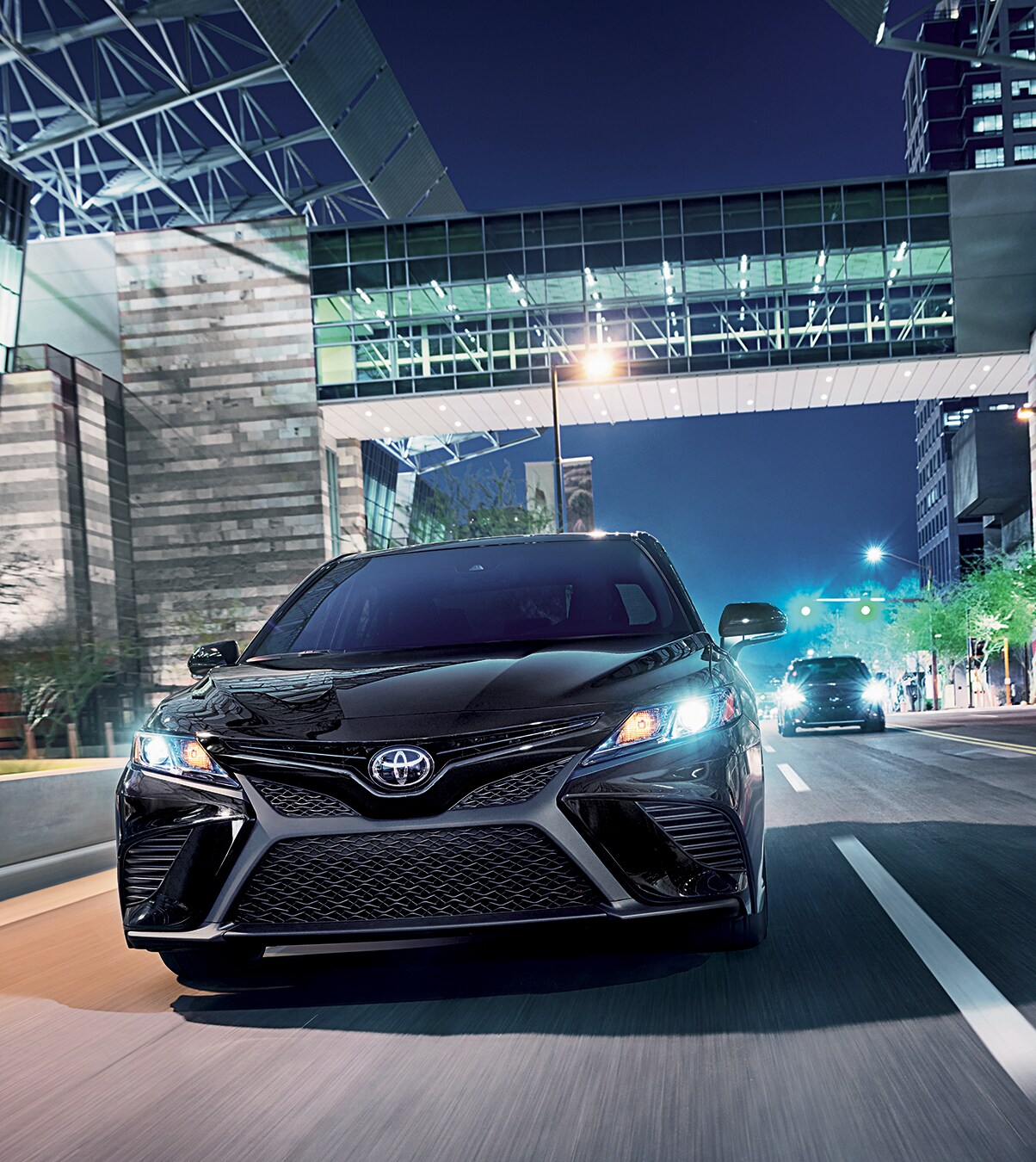 blackheadoncamry.jpg black camry driving through the city