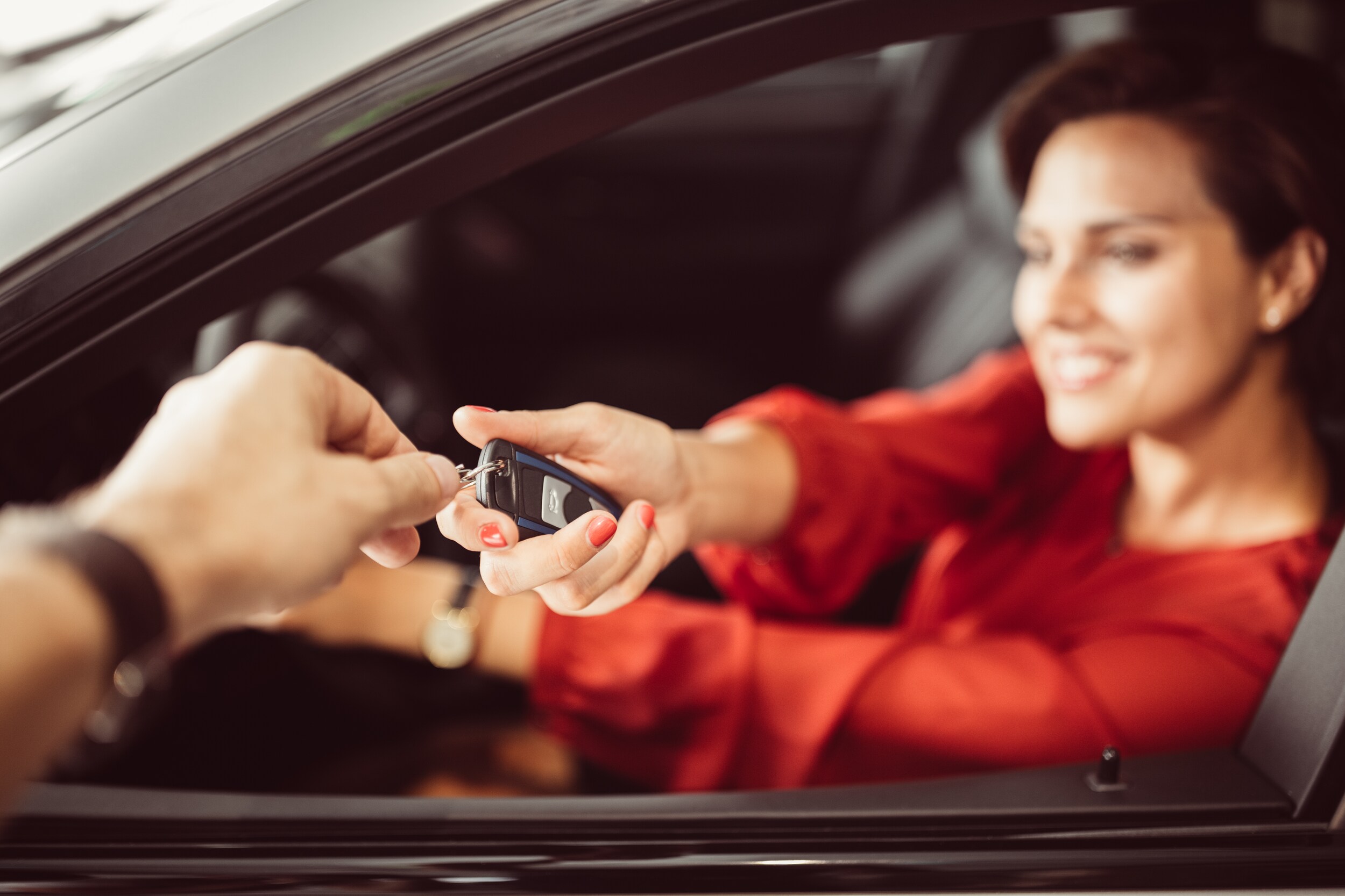 used-cars-bob-penkhus.jpg woman in red accepting car keys on a used car she purchased