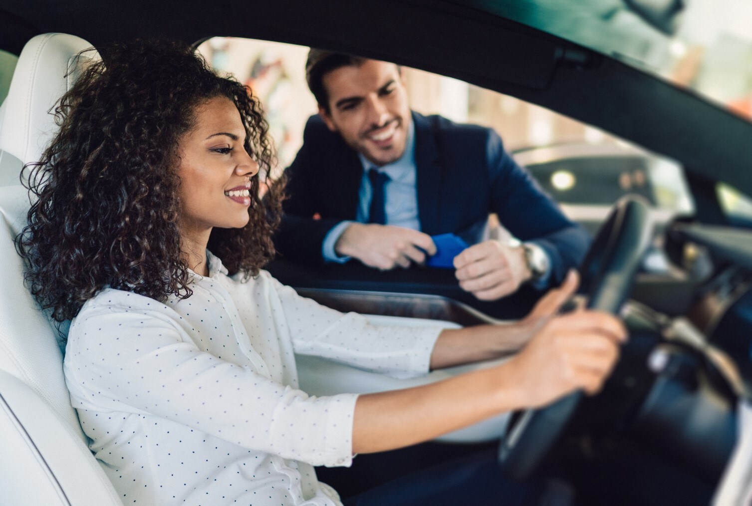sm-new-vs-used-cars-bob-penkhus-dealerships.jpg woman sitting in the drivers seat ready to test driving a vehicle