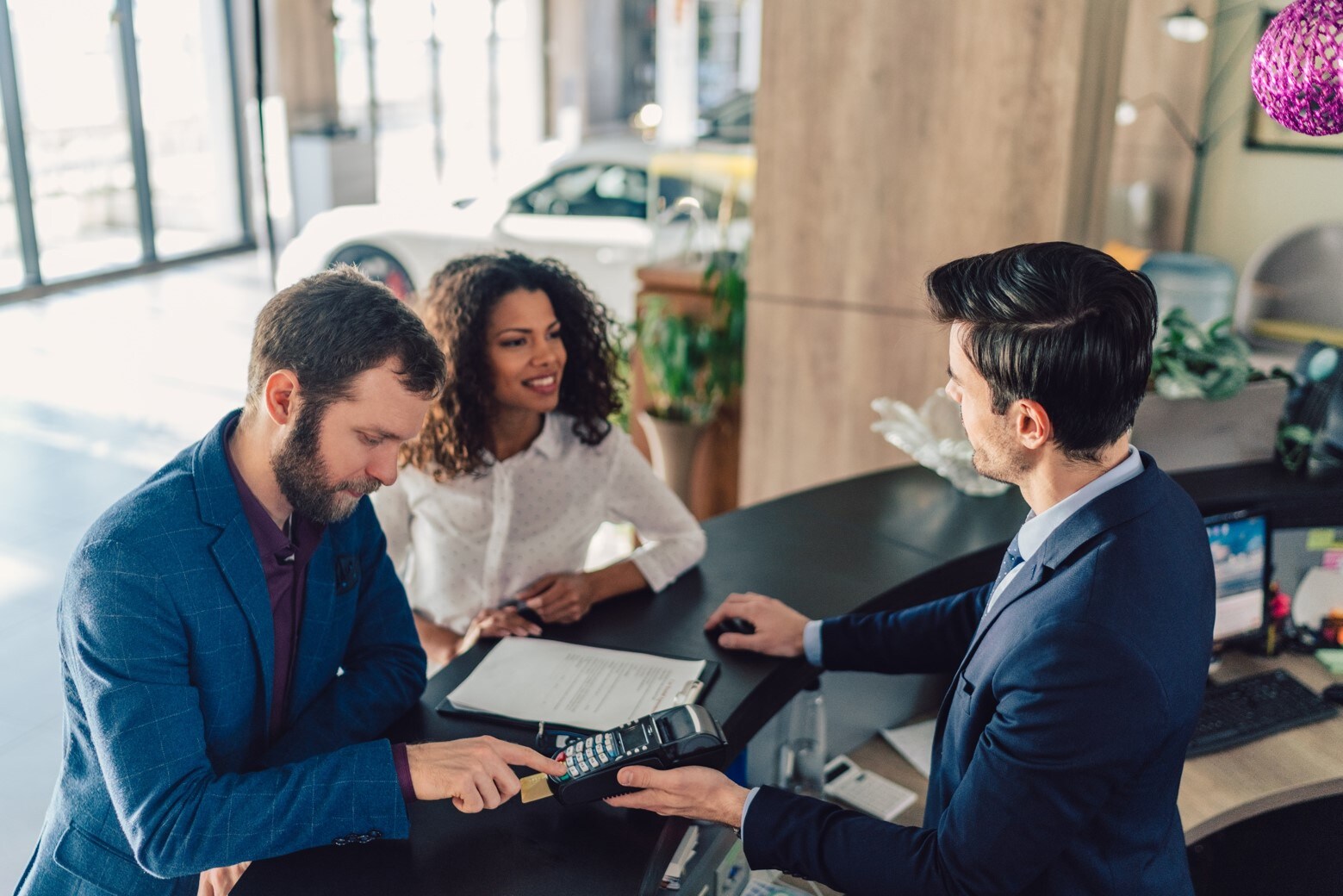 sm-new-vs-used-cars-bob-penkhus-dealerships-colorado.jpg woman comparing financial forms to buy a new or used car