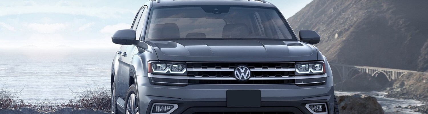 2018 VW Atlas for Sale in Colorado Springs Bob Penkhus Dealerships.png Front exterior view of a 2018 used Volkswagen Atlas parked on a cliff by a bay of water